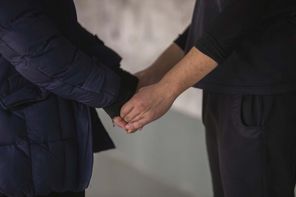 holding hands blue jacket person